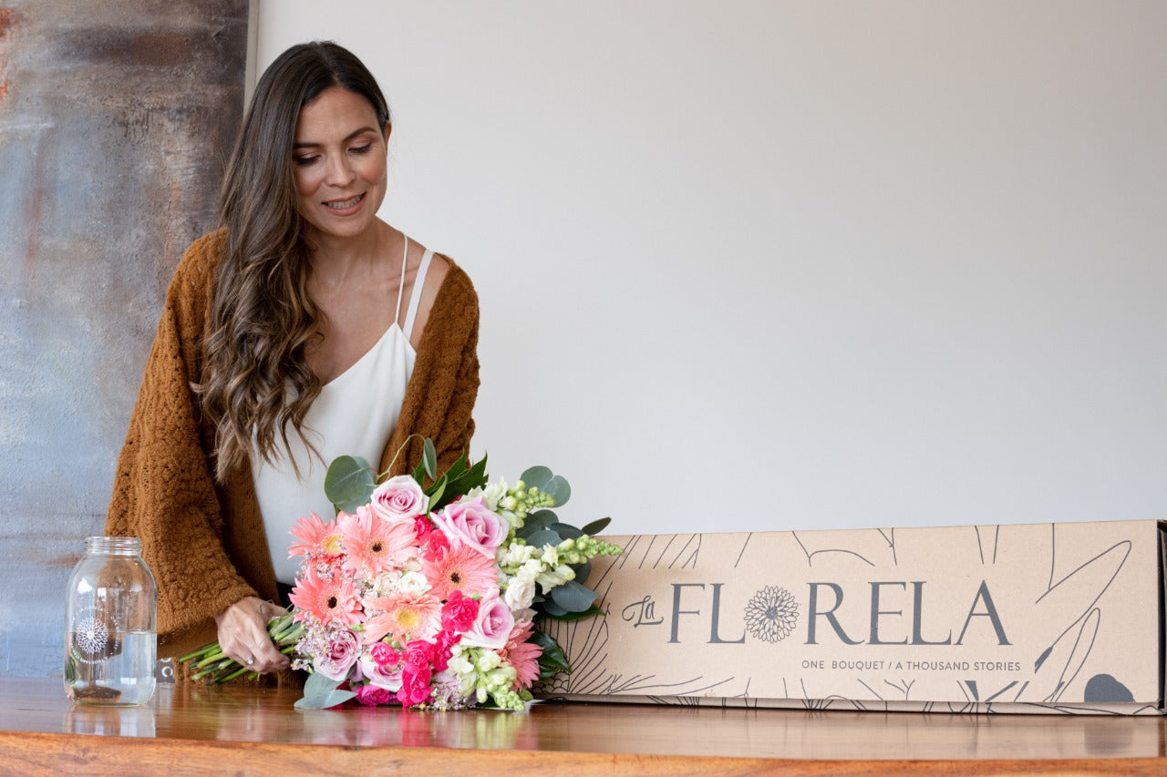 Woman opening flower box - La Florela